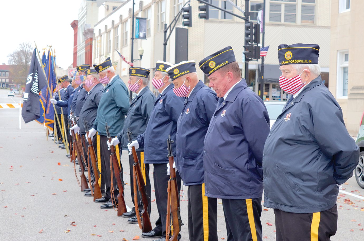 Members of the Crawfordsville Honor Guard bow their heads for a moment of silence in rememberance of the fallen Wednesday on Green Street.